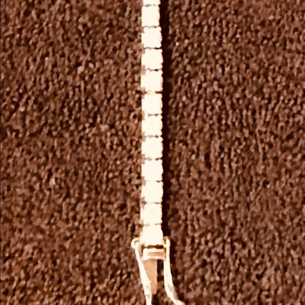 Diamonds and silver tennis bracelet.